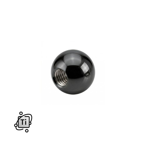 Czarna nakrętka z tytanowa na pręty z gwintem zewnętrznym.