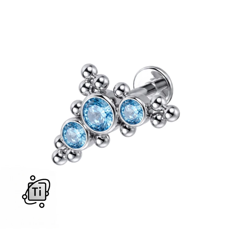 Labret ornamentowy z tytanu w formie łuku z 3 błękitnymi cyrkoniami i kulkami
